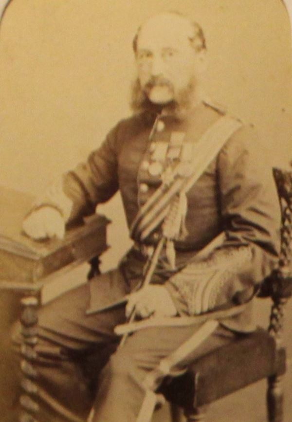 photo of a balding man with large side whiskers in officer's uniform